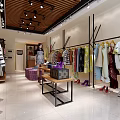 Fashionable Clothing Store Interior With Trendy Clothes On Racks Purple Ottoman And Wooden Shelves