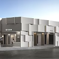 Modern Storefront Facade With White Geometric Panels And Bright Lighting Design