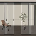 Modern Glass Sliding Doors with Black Frames in Interior Room Featuring Chair And Plant