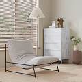 Modern Light Gray Chaise Lounge With Black Metal Frame By Window Blinds And Marble Drawers