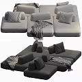 Large Gray Sectional Sofa with Multiple Plush Pillows and Soft Blanket for Cozy Living Room