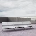 Outdoor Public Metal Bench With Concrete Wall Railing And Brick Pavement