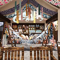 Traditional Fabric Store With Wooden Shelves Hanging Clothes And Stacked Blue White Patterned Fabrics
