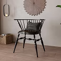 Dark Wooden Dining Chair With Striped Cushion Woven Wall Decor Hanging Lamp And Green Plant