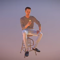 A Man Sitting On Stool Holding Phone Wearing Gray Long Sleeve Shirt And Light Pants