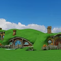 Hobbit Style Houses With Green Grassy Roofs Round Doors Windows And Blue Sky White Clouds