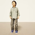 Little Boy Smiling In Light Background Wearing Green Checkered Shirt Gray Pants Blue Shoes