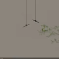 Two Modern Pendant Lights With Leaf Shaped Shades Black Cords and Illuminated Bulbs