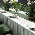 Elegant Dining Table Set With Long White Tablecloth Green Velvet Chairs And Flower Arrangements