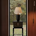 Dark Colored Bedside Table With Black Base Table Lamp And Natural View Outside Window
