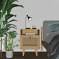 Natural Wooden Bedside Table With Lamp Books And Monstera Plant Next To Bed