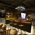 Modern Industrial Bar Interior With Large LED Screen Brick Wall Wine Rack And Round Tables