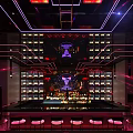 Modern Bar Interior With Colorful Neon Lights LED Screen And Comfortable Orange Seating