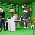 People Using VR Headsets In Green Room With Shelves Plants And Camera Tripod