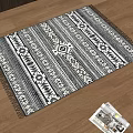 Black And White Square Carpet With Geometric Pattern And Fringed Edges On Wooden Floor