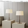 Two Modern Floor Lamps With White Fabric Shades And Metal Stands On White Cube Bases