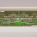Green Plant Wall Featuring Motivational Keywords Like Struggle Attitude Brand Culture Future