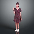 Woman In Red Floral Dress Standing Against Gray Background Holding Small Object With White Shoes