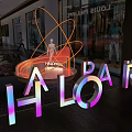Halopark Indoor Neon Circular Installation With Orange Yellow Glow Mannequin And Plants