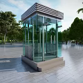 Modern Glass Security Booth With Transparent Walls In Outdoor Plaza With Trees And Blue Sky