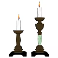 Lit White Candles On Two Dark Base Candle Holders With Green Columns And Different Heights