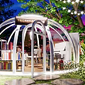 Park Landscape Featuring White Dome Structure With Bookshelves Books Green Trees And Decorative String Lights