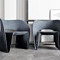 Two Modern Leisure Chairs With Curved Dark Sleek Design In Interior