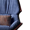 Modern Blue Lounge Chair With Red Trim And Brown Diamond Patterned Pillow On Wooden Base