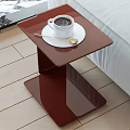 Red Modern Side Table With Coffee Cup And Spoon Next To Sofa