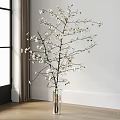 Transparent Glass Vase With White Flowering Branches Against White Wall And Wooden Floor