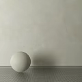 White Sphere Decorative Component Placed On Gray Floor Against Light Wall