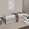 Serene Massage Room Setup With White Table Brown Towel And Skincare Shelf