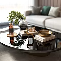 Decorative Ornaments Set on Modern Glass Coffee Table with Green Plant Silver Vase Gold Tray