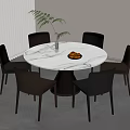 Stylish Round White Marble Dining Table With Black Brown Chairs Fruit Bowl And Green Plant