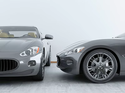 Two Gray Sports Cars with Classic Grilles Parked in Modern Indoor Studio 3d model
