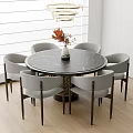 Round Black Marble Dining Table Set With Six Gray Chairs And Orange Flower Vase