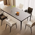Modern Dining Table Set with Black and White Chairs Vase Green Plant and Fruit Bowl