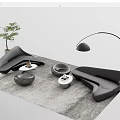 Modern Curved Black Sofa And Coffee Table Set With Gray Rug Floor Lamp And Plant