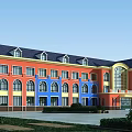 Colorful School Building With Red And Blue Walls Multiple Arched Windows And Green Lawns