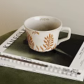Elegant White Cup With Golden Leaf Designs On KINFOLK Lifestyle Magazine