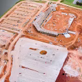 Aerial View Of Large Construction Site With Multiple Building Areas And Foundation Work