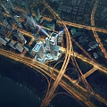 Aerial View of Modern Office Building Surrounded by Urban Traffic Network With Illuminated Night Lights
