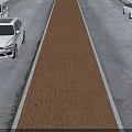 Road Infrastructure With Central Brick Paved Strip Between Traffic Lanes And Cars