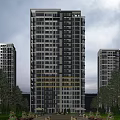 Modern High Rise Residential Building With Glass Curtain Walls Lit Windows And Urban Surroundings