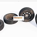 Four Worn Automotive Tires With Metal Rims Arranged On White Background