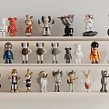 Colorful Decorative Figurines with Various Designs Displayed on Shelves in Multiple Colors