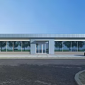 Modern Commercial Building Exterior With Glass Windows Entrance White Car Trees And Blue Sky