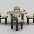 Round Wooden Dining Table With Four Green Cushioned Chairs And Glass Vase Plant