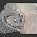 Ancient Circular Castle Ruins Featuring Stone Walls And Central Tower In Arid Landscape