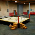 Indoor Boxing Training Ring With Wooden Steps And Ropes In Fitness Area